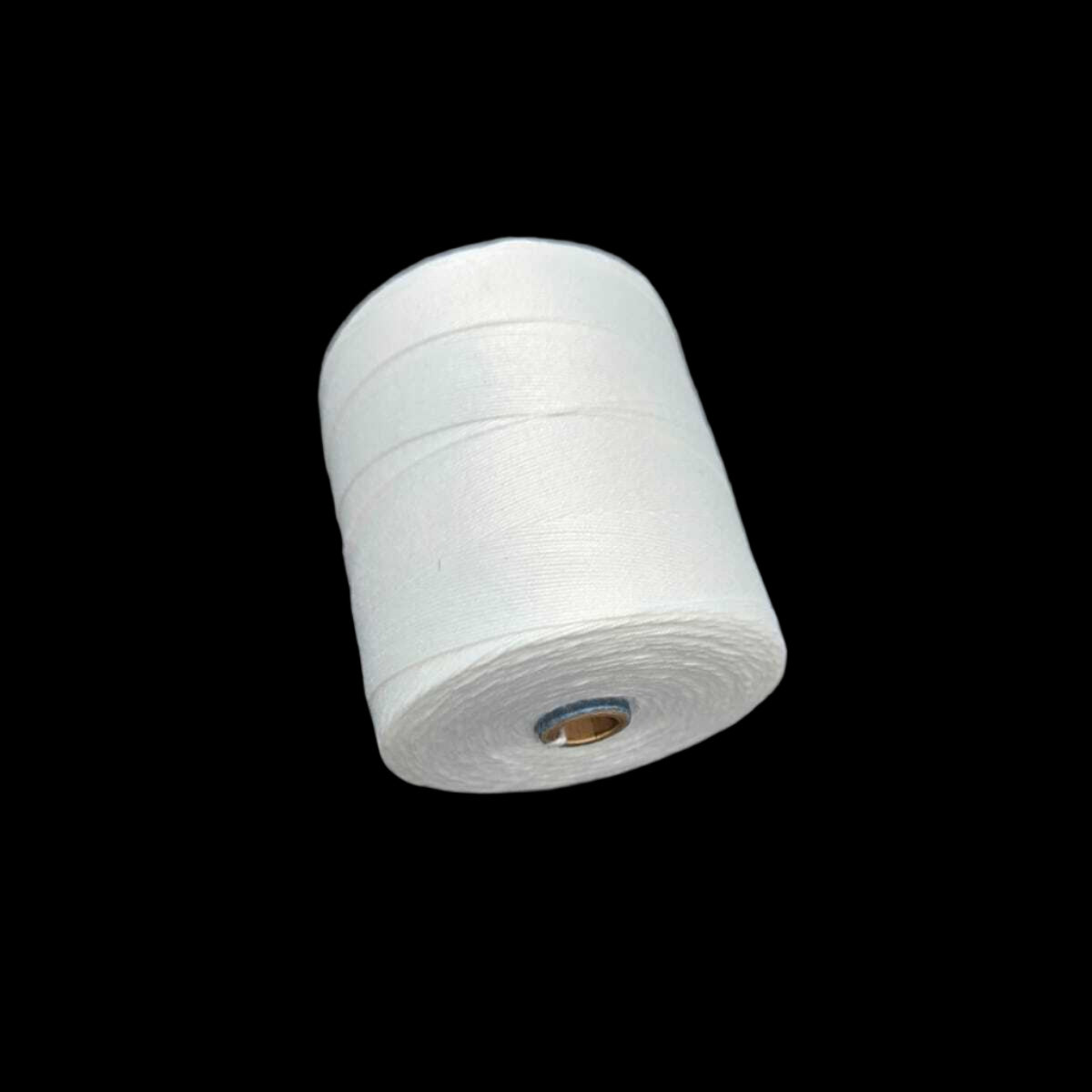 White reel of string on a textured gray surface